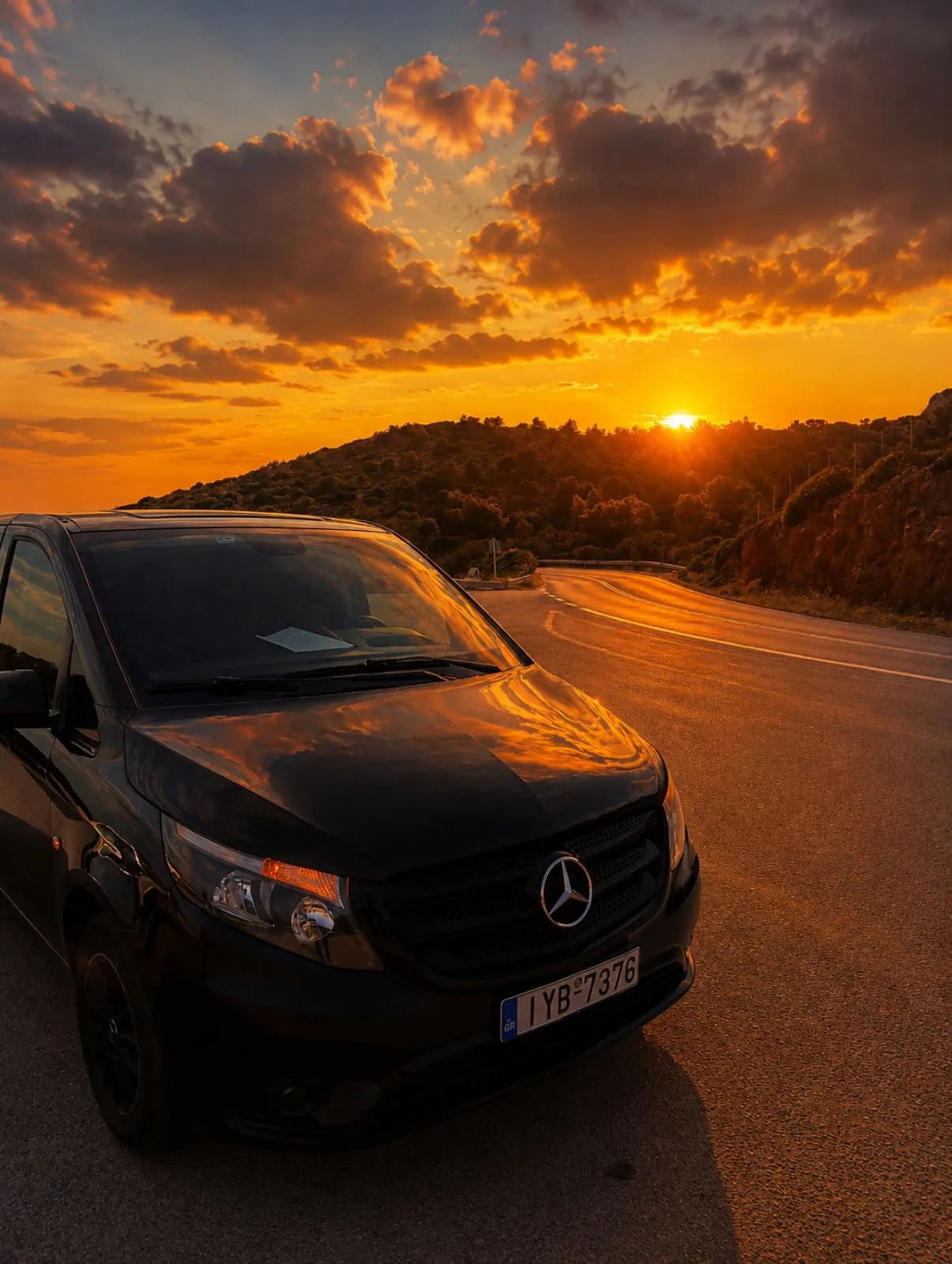 Mercedes Vito chauffeur car at Greek sunset on a coastal road